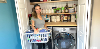 Image: Jessica stands in front of her washer and dryer with a basket of laundry