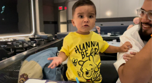 Image: A toddler dining with his family