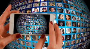Image: A woman using a phone to capture the screen of another device