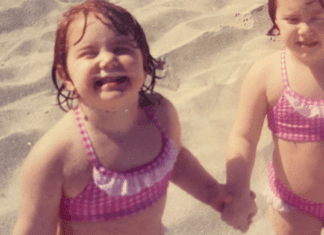 2 toddler girls happy on the beach