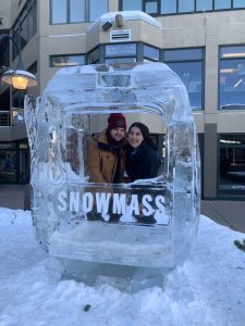 A couple poses for a picture in at ice sculpture in Snowmass, CO