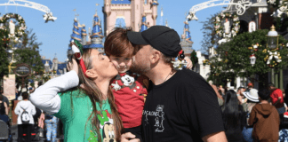 Holidays at Disney: A Very Merry Holiday at Walt Disney World Sandra and her family pose for a photo at Magic Kingdom