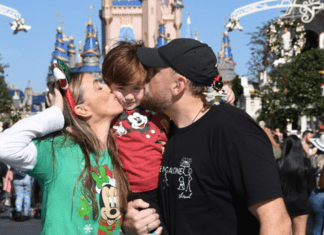 Holidays at Disney: A Very Merry Holiday at Walt Disney World Sandra and her family pose for a photo at Magic Kingdom
