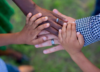 A family putting their hands together