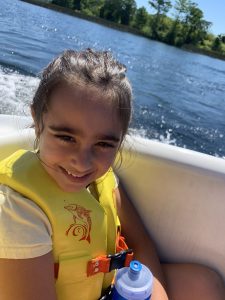 A child riding in a Mickey Mouse Boat
