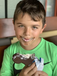 A child enjoying a Mickey ear-shaped ice cream treat