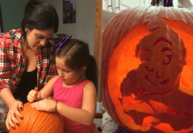 Diana helps her daughter carve a pumpkin for Halloween