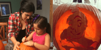 Diana helps her daughter carve a pumpkin for Halloween