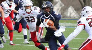 A football player runs with the ball during a play