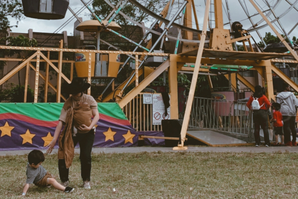 Jacqueline helping her son work through sensory overload at a carnival
