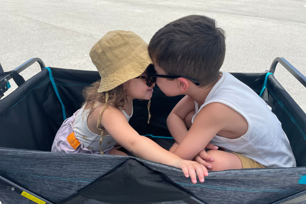 Two children sitting in a wagon