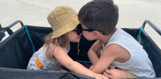 Two children sitting together in a wagon