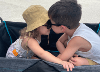 Two children sitting together in a wagon
