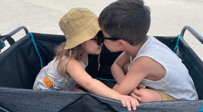 Two children sitting together in a wagon