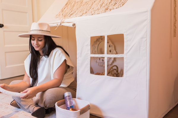 Jacqui sits in front of her daughter's canvas house