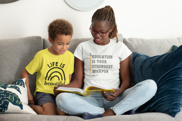 A woman and child sit and enjoy a book together