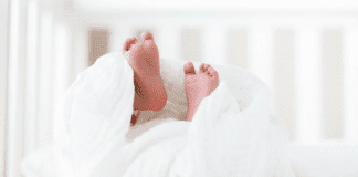 Baby feet sticking out from a blanket