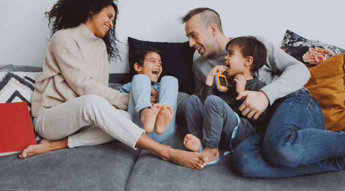 A Thank You to the Partner Who Carries Their Weight in Parenting A family hanging out a laughing together