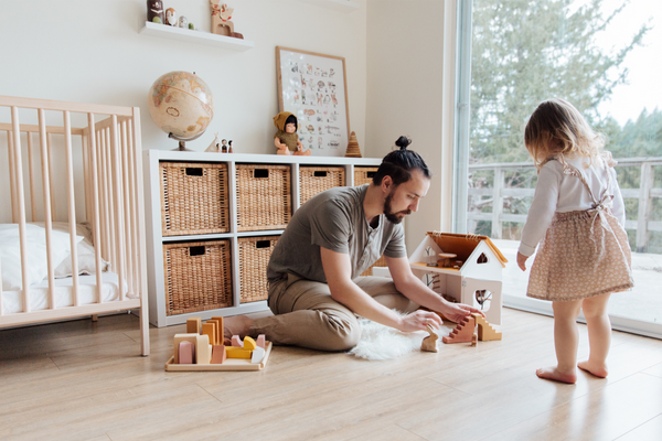 A dad playing with his preschool-aged daughter