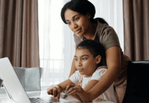 A mom helps her daughter with her school work