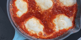 A pan of marinara sauce and mozzarella cheese