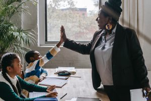 A teacher high fives one of her students