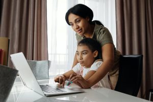 A mom helps her daughter with homework