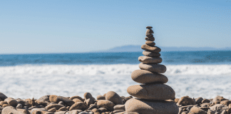 A pile of rocks stacked on the shore