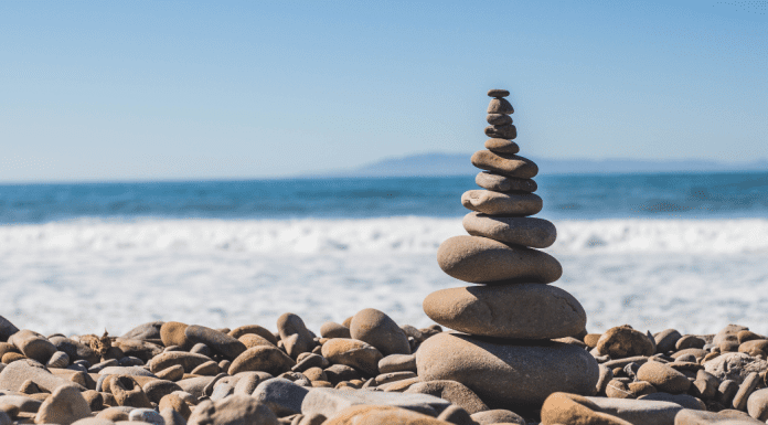 A pile of rocks stacked on the shore
