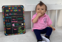 The First Day of School: 5 Helpful Tips For Preparing Your Child A toddler sits next to a My First Day of School board