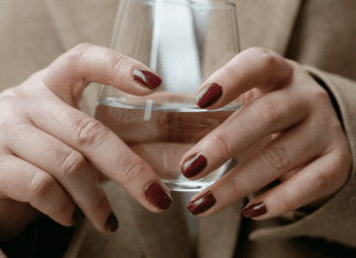 A corporate woman holding a glass of water