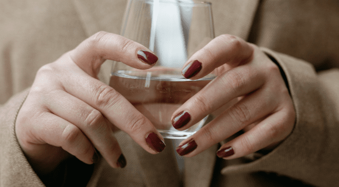 A corporate woman holding a glass of water