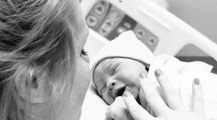 Mom getting ready to breastfeed for the first time in the hospital