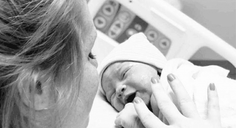 Mom getting ready to breastfeed for the first time in the hospital