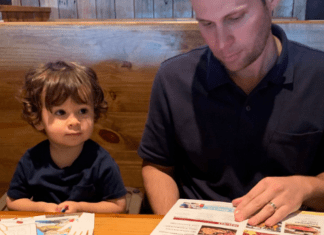 Ana-Sofia's husband and son looking at menus at Miller's Ale House