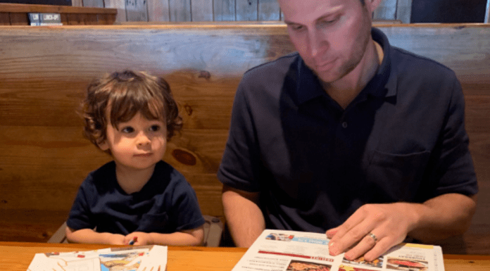 Kids Eat Free (or Cheap) Miami Restaurant Guide Ana-Sofia's husband and son looking at menus at Miller's Ale House