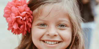 Common Pediatric Dental Procedures, Part 2 | Dr. Bob Pediatric Dentist A little girl with a flower in her hair, showing off her smile