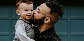 Father’s Day Gift Guide 2022 A father holding giving his toddler-aged son a kiss on the cheek