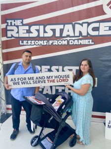 The Solano family in front of a Resistance-themed banner