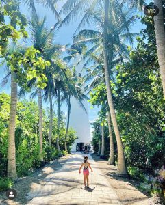 A little girl walking toward the lighthouse at Bill Baggs
