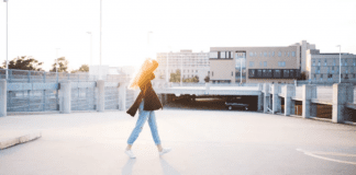 A woman walks across a street