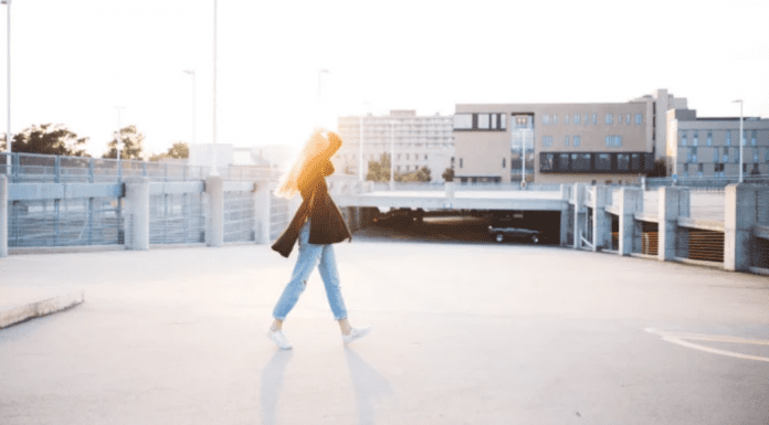 A woman walks across a street