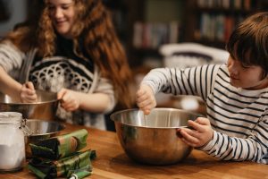 Two children helping to prepare a meal