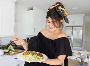 Michele holding a plate of homemade arroz con gandules