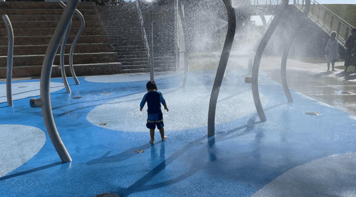 Free Things to Do in Miami With Kids A little boy enjoying a splash pad at a local playground
