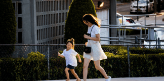 A mom running alongside her daughter