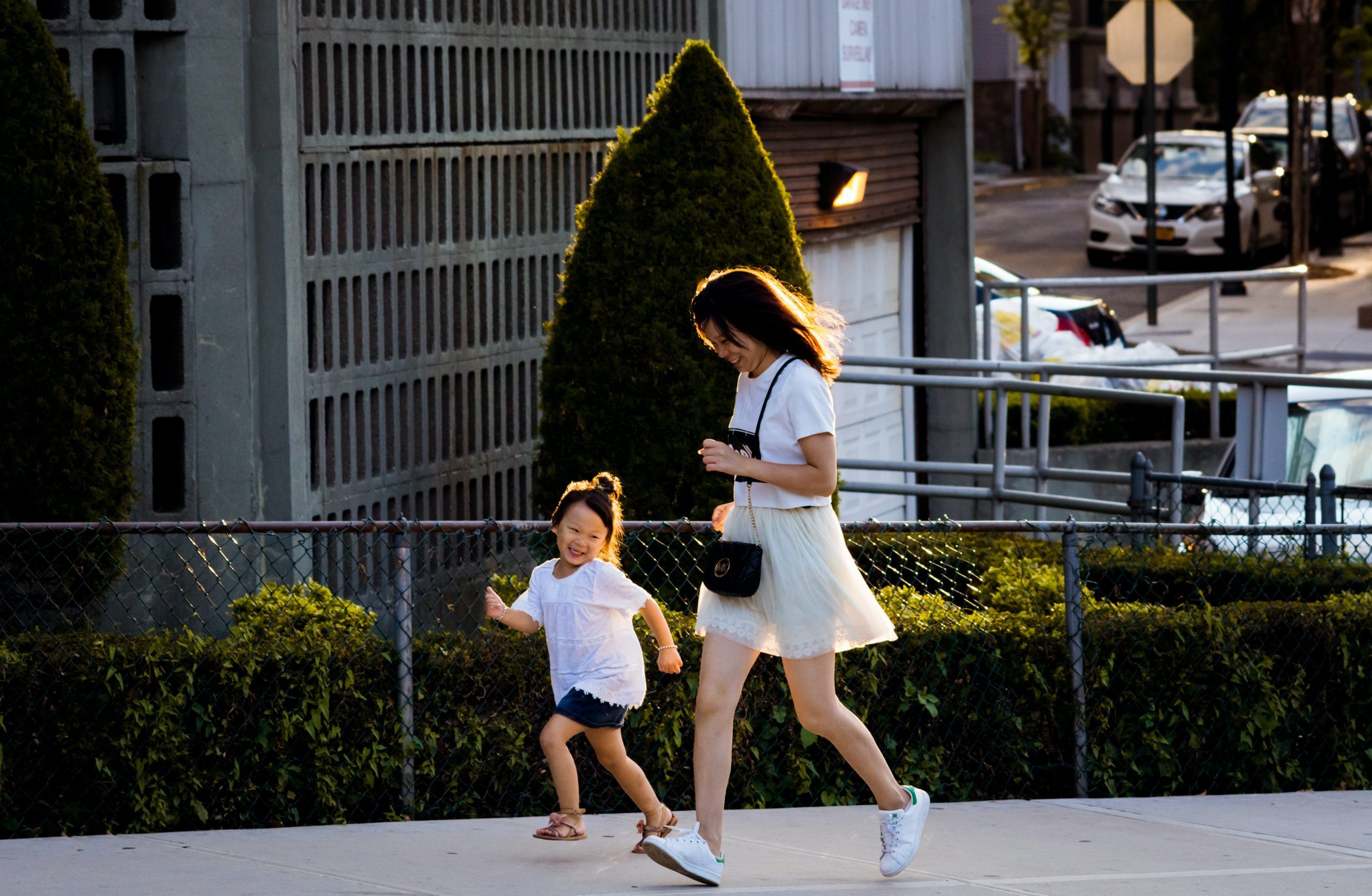 A mother running alongside her daughter