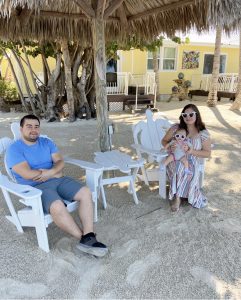 Rachel and her family relaxing under the tiki hut