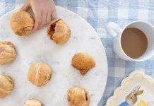 Resurrection Rolls Recipe: A Sweet Easter Tradition Image: Child's hand taking a Resurrection Roll off of a plate to enjoy
