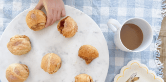 Image: Child's hand taking a Resurrection Roll off of a plate to enjoy